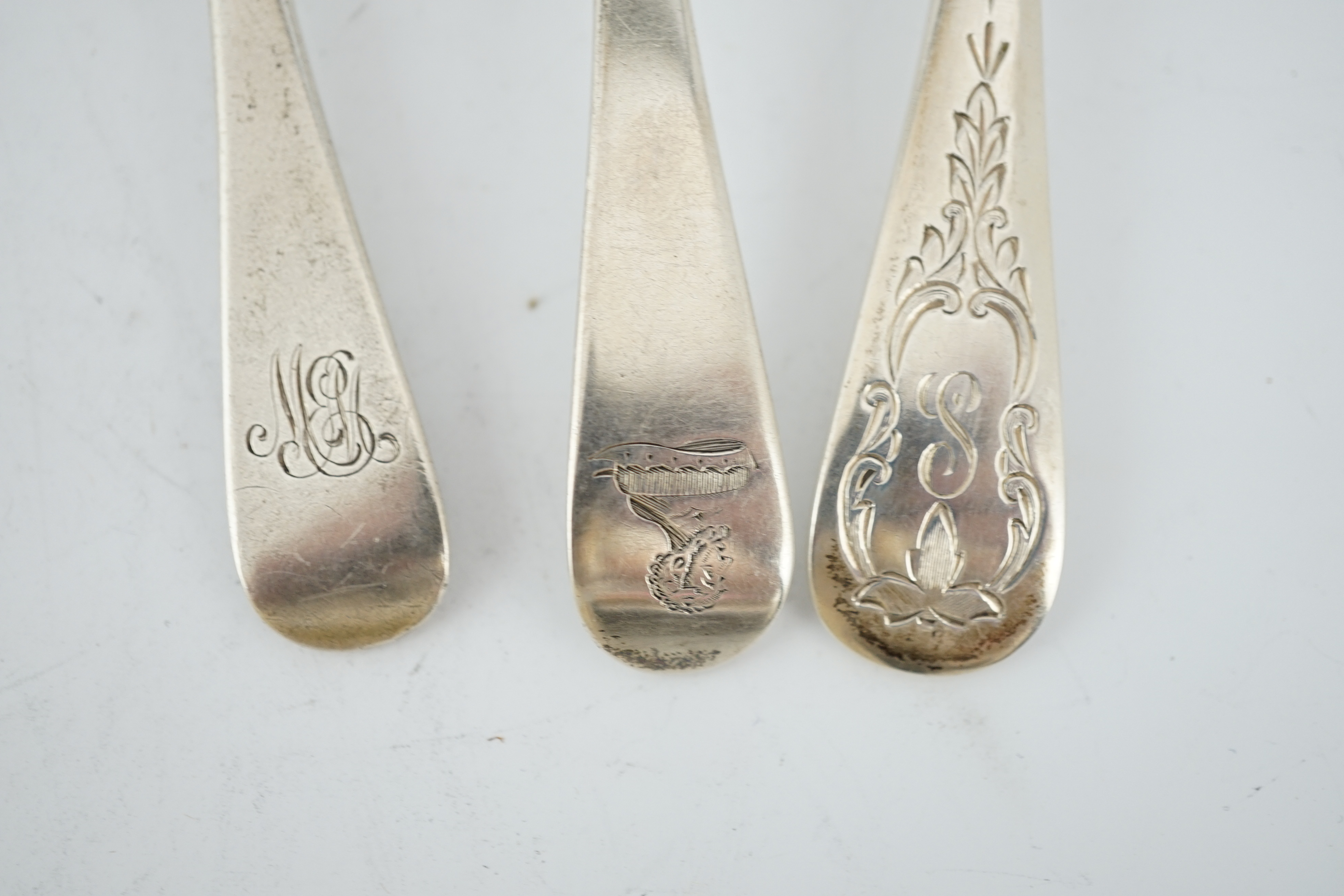 A small collection of assorted mainly 19th century silver dessert spoons, various dates, makers and patterns and two pairs of sauce ladles, London, 1824 and London, 1830